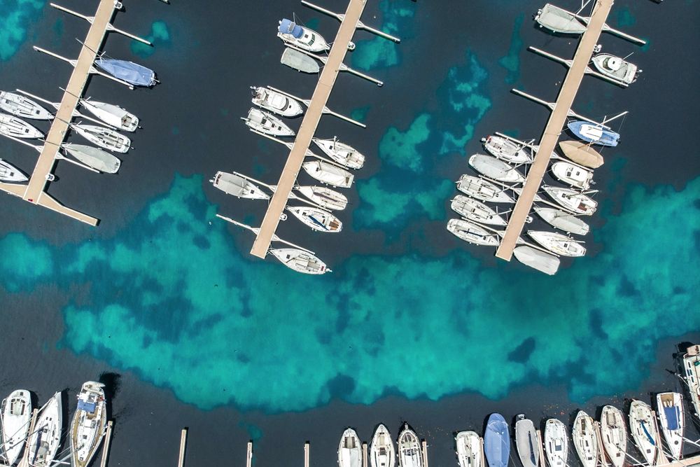 Boats moored along jetties at a marina